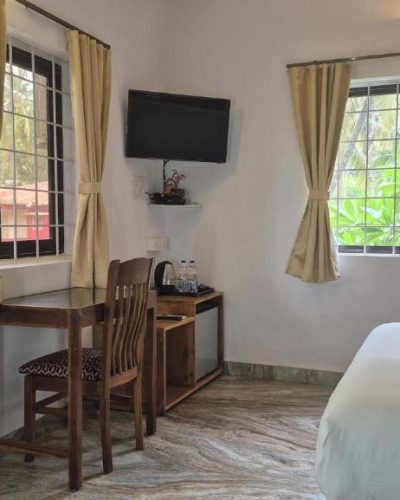 In-room amenities including mini fridge, kettle, and glasses