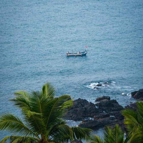 Guests enjoying a walk along Candolim Beach near the villa